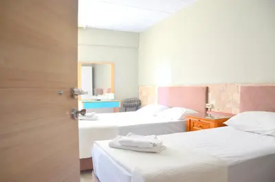 a hotel room with two beds with white sheets at Elite Hotel City Center Saray Bed and Breakfast in Saray