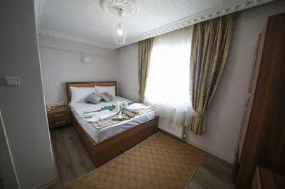 a small bedroom with a bed and a window at DELBAB HOTEL in Istanbul