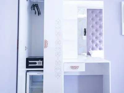 a white kitchen with a stove and a sink at The Zanadu İstanbul in Istanbul