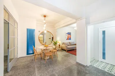 a dining room with a table and chairs and a mirror at Mayer Tatarbey Apartments in Istanbul