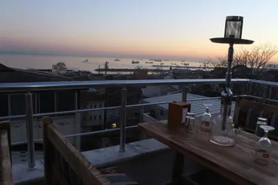 a table on a balcony with a view of a city at Reggae in Istanbul