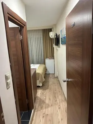 a hallway of a hotel room with a bed and a door at Reggae in Istanbul
