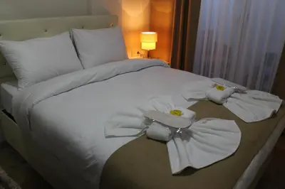 a bed with white sheets and towels on it at Reggae in Istanbul