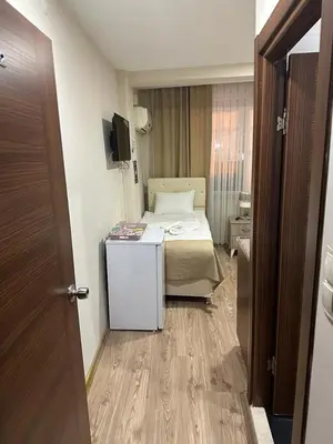 a small room with a bed and a television at Reggae in Istanbul