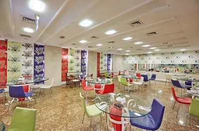 a restaurant with colorful chairs and tables in a room at Konak Hotel Taksim in Istanbul