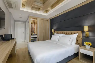 a bedroom with a white bed and a black wall at Gleam Bomonti Hotel in Istanbul