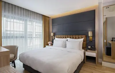 a bedroom with a large bed and a large window at Gleam Bomonti Hotel in Istanbul