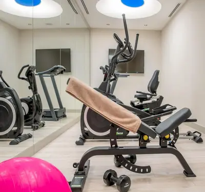 a gym with tread machines and a red exercise ball at Gleam Bomonti Hotel in Istanbul