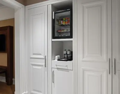 a white kitchen with white cabinets with a microwave at Rotta Hotel Istanbul in Istanbul