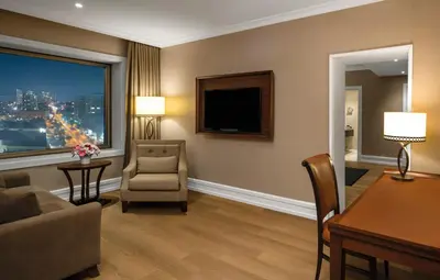 a living room with a couch and a chair and a window at Rotta Hotel Istanbul in Istanbul