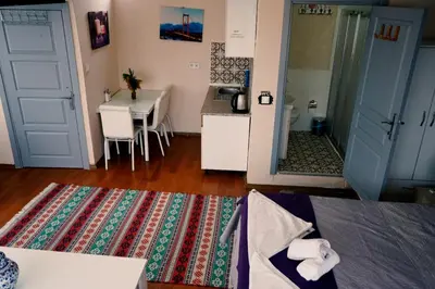 a room with a table and a kitchen with a tableablish at Medellin Apart Hotel Istanbul in Istanbul
