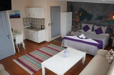 a bedroom with a bed and a couch and a table at Medellin Apart Hotel Istanbul in Istanbul