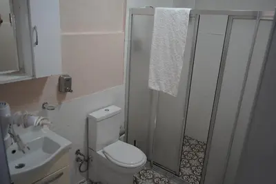 a bathroom with a toilet and a shower and a sink at Medellin Apart Hotel Istanbul in Istanbul