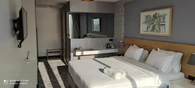 a bedroom with a large bed with white sheets at Four-G Hotel in Istanbul