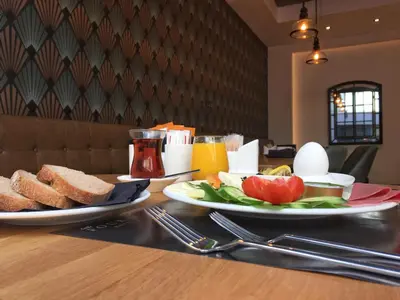 a table with two plates of bread and eggs and toast at Four-G Hotel in Istanbul