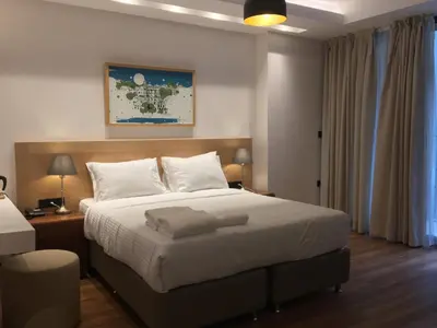 a bedroom with a large bed with white sheets at Four-G Hotel in Istanbul