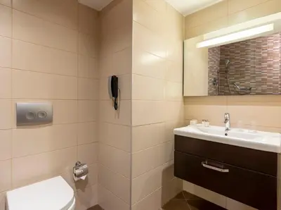 a bathroom with a toilet and a sink at Occidental Taksim in Istanbul