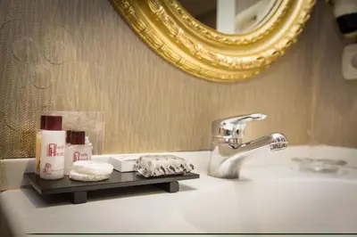 a bathroom counter with a sink and a mirror at Osmanbey Fatih Hotel in Istanbul