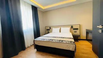 a bedroom with a bed and a window at Osmanbey Fatih Hotel in Istanbul