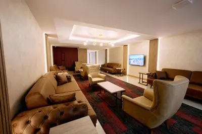 a living room with couches and chairs in a hotel room at Osmanbey Fatih Hotel in Istanbul