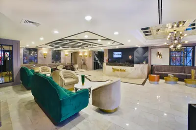 a hotel lobby with green chairs and a bar at Four Sides Taksim Lion Hotel&Spa in Istanbul