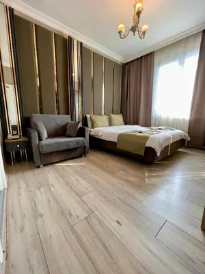 a bedroom with a bed and a couch and a chair at New Taksim Hotel in Istanbul