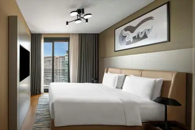 a bedroom with a large white bed and a window at Radisson Residences Vadistanbul in Istanbul