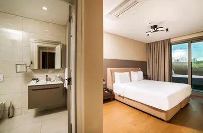 a hotel room with a bed and a bathroom at Radisson Residences Vadistanbul in Istanbul