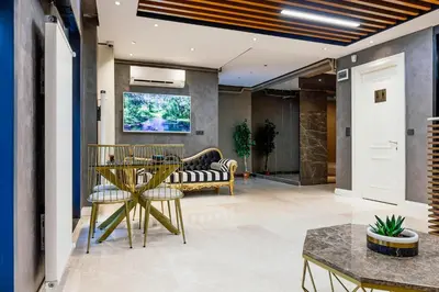 a lobby with a couch and a table and chairs at Norah Suites Hotel İstanbul in Istanbul
