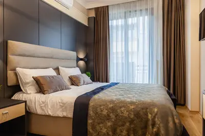 a bedroom with a large bed with a large window at Norah Suites Hotel İstanbul in Istanbul