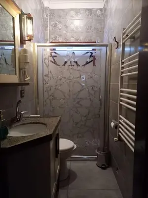 a bathroom with a shower with a toilet and a sink at Kayıbeyi Hotel & Restaurant in Bursa