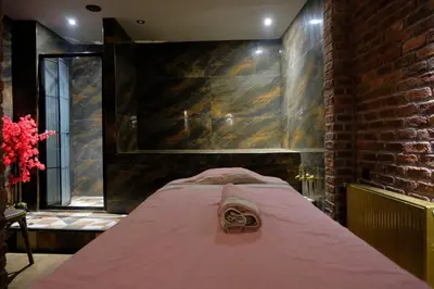 a bed in a room with a brick wall at Kayıbeyi Hotel & Restaurant in Bursa