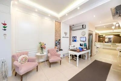 a living room with pink chairs and a table at Mr. Bird Hotel in Istanbul