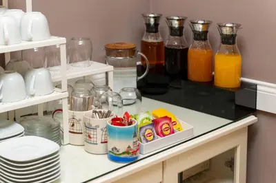a kitchen counter with bottles of juice and drinks at Mr. Bird Hotel in Istanbul