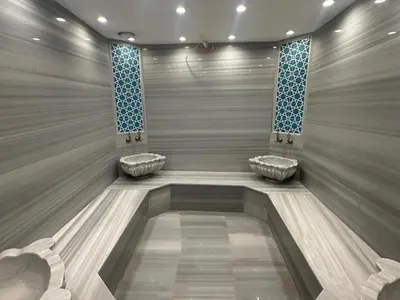 a bathroom with three sinks in the middle of a room at Maywood Hotel in Istanbul