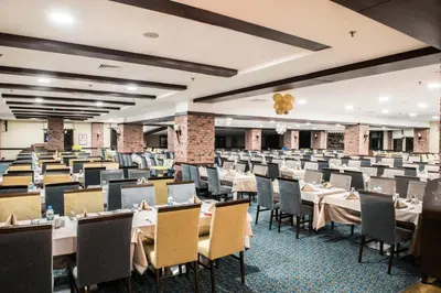an empty dining hall with tables and chairs at Karinna Hotel Convention Center & Spa Luxury - Full Board Plus in Uludag
