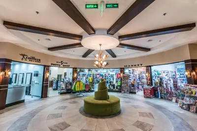 a store lobby with a green ottoman in the middle at Karinna Hotel Convention Center & Spa Luxury - Full Board Plus in Uludag