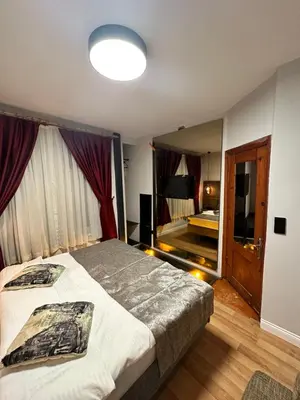 a bedroom with a large bed and a mirror at Corner Hot in Istanbul
