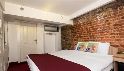 a bedroom with a brick wall and a bed at Corner Hot in Istanbul