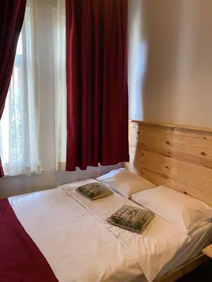 a bed with two pillows on it next to a window at Corner Hot in Istanbul