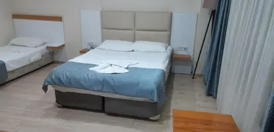 a small bedroom with two beds and a table at Arya Hotel in Istanbul