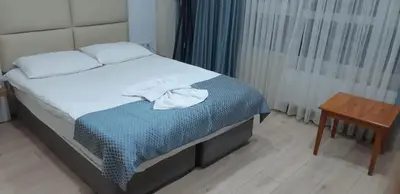 a bedroom with a bed with a towel on it at Arya Hotel in Istanbul