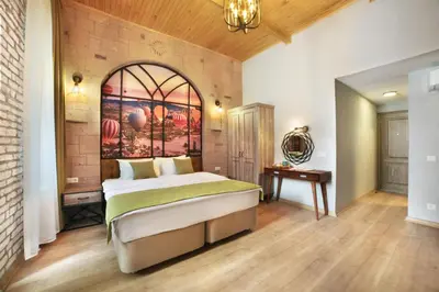 a bedroom with a large bed with a painting on the wall at Ardilas Residence in Istanbul