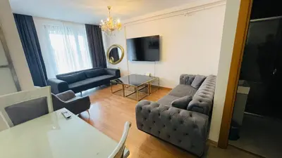 a living room with a couch and a table at CTS Elysium Residence Duplex Apt. 85 in Istanbul