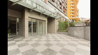 a building with a tiled sidewalk in front of it at CTS Elysium Residence Duplex Apt. 85 in Istanbul