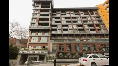 a tall building with a car parked in front of it at CTS Elysium Residence Duplex Apt. 85 in Istanbul