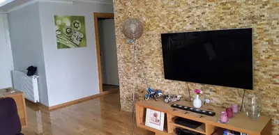 a living room with a flat screen tv on a brick wall at Boğazın incisi.. in Istanbul