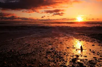 a sunset on a beach with the ocean at istanbul Airport Kumsal Otel in Arnavutköy