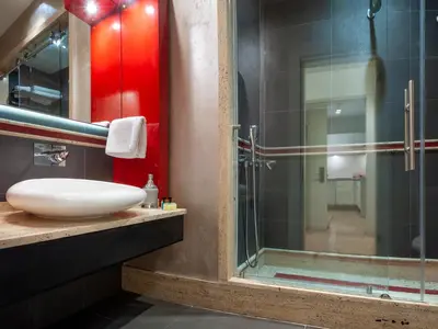 a bathroom with a sink and a glass shower at Armoni Residence & Hotel in Istanbul