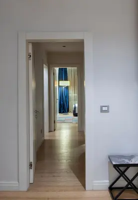 a hallway with white walls and wood floors at Armoni Residence & Hotel in Istanbul